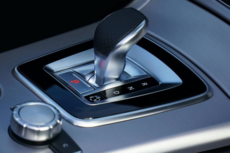 Mechanic diagnosing car vibration issues when vehicle is in drive but runs smoothly in neutral. Common causes include damaged motor mounts, worn CV joints, misaligned wheels, and transmission problems requiring professional inspection