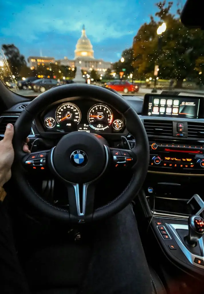 A close-up of a BMW dashboard with the check engine light illuminated, signaling a potential engine issue that needs diagnosis.