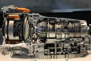 A detailed cutaway diagram explaining gearbox components and their functions, showing how gears, shafts, and synchronizers work together inside a manual transmission